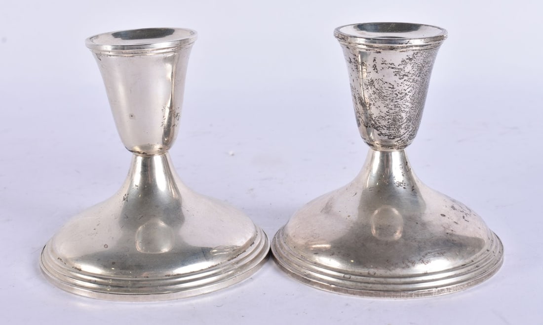 A PAIR OF SILVER CANDLESTICKS. 440 grams overall. 6 cm high. (1 of 5)