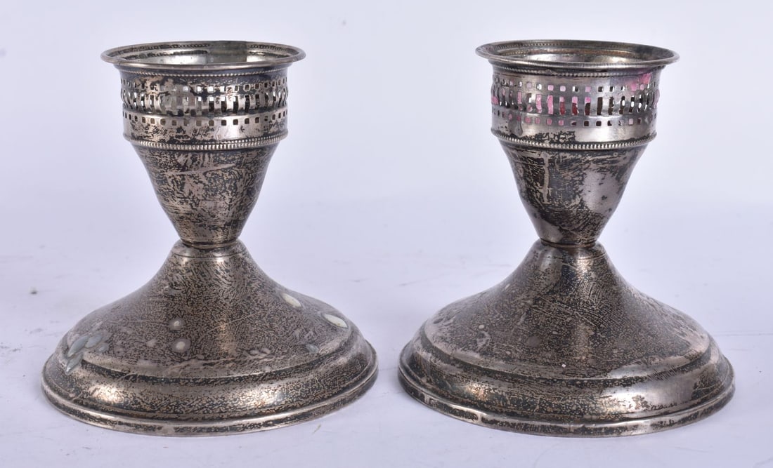 A PAIR OF OPENWORK SILVER CANDLESTICKS. 330 grams overall. 9.5 cm high. (1 of 5)