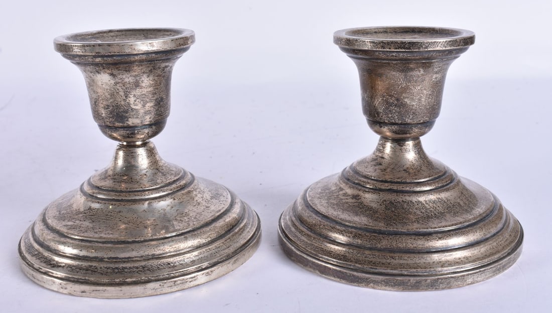 A PAIR OF SILVER CANDLESTICKS. 813 grams overall. 6 cm high. (1 of 5)
