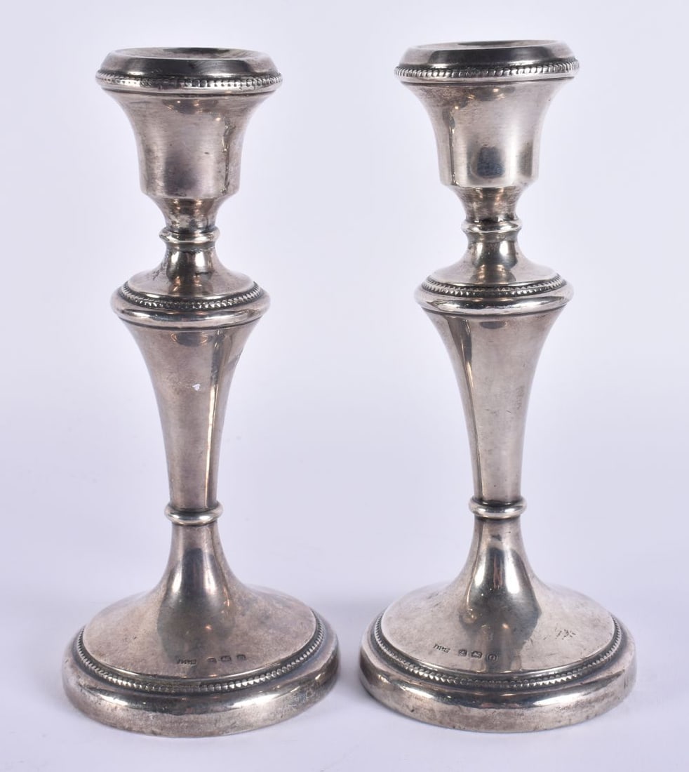 A PAIR OF SILVER CANDLESTICKS. 455 grams overall. 14cm high. (1 of 5)