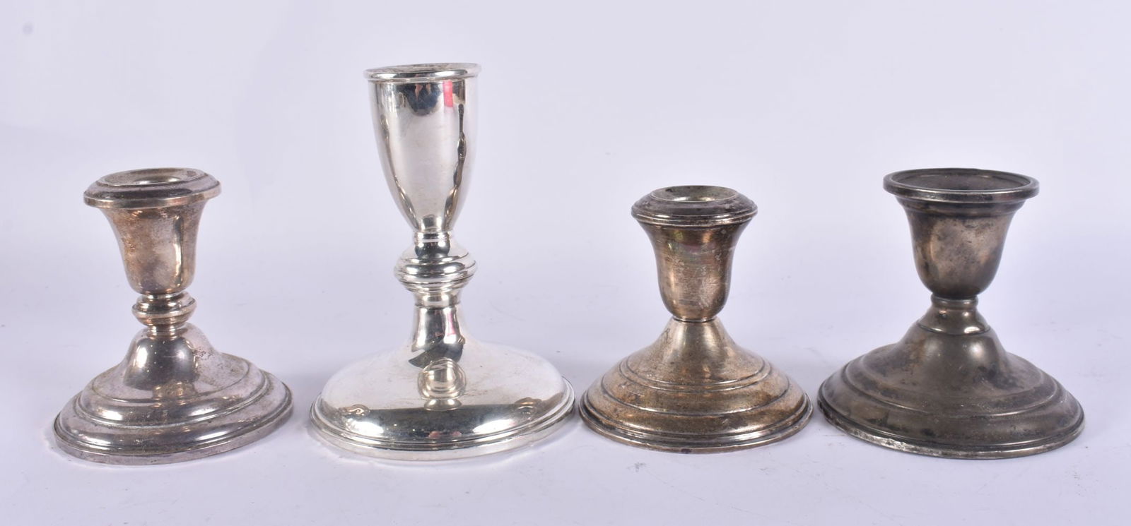 FOUR SILVER CANDLESTICKS. 1080 grams overall. (4) (1 of 7)