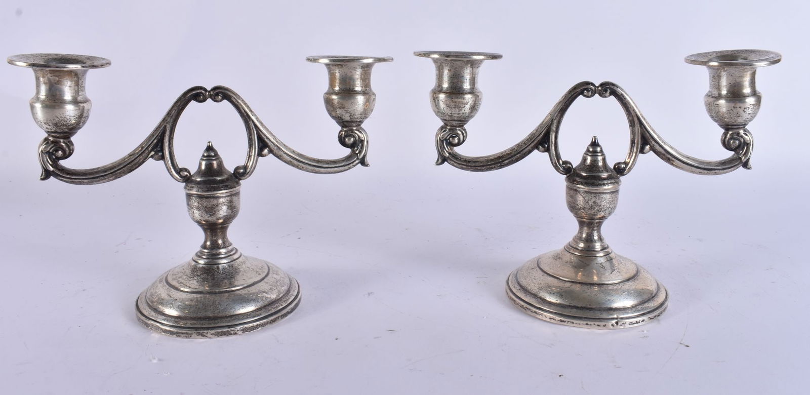 A PAIR OF SILVER CANDLESTICKS. 570 grams overall. 15 cm x 18 cm. (1 of 6)