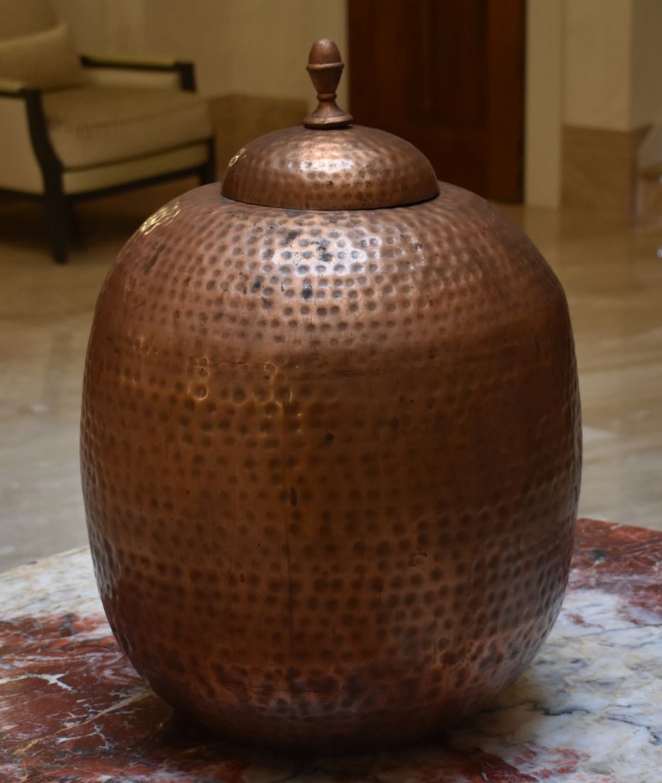 A LARGE TIBETAN HAMMERED COPPER POT AND COVER. 58cm x 26 cm.: A LARGE TIBETAN HAMMERED COPPER POT AND COVER. 58cm x 26 cm.