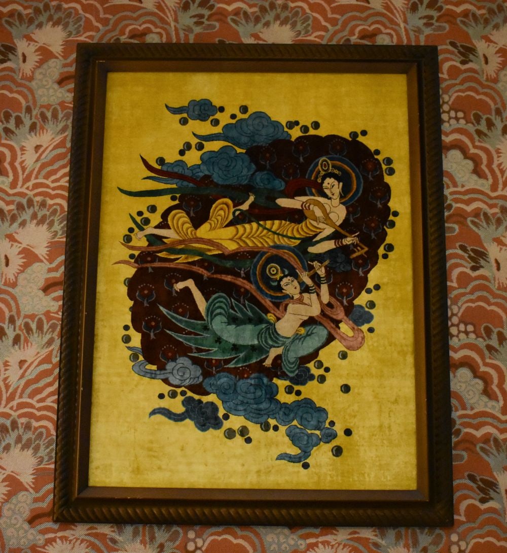 A VERY LARGE EASTERN EMBROIDERED PANEL depicting two immortal musicians in flight. 132 cm x 105 cm,: A VERY LARGE EASTERN EMBROIDERED PANEL depicting two immortal musicians in flight. 132 cm x 105 cm, panel 115 cm x 85 cm.