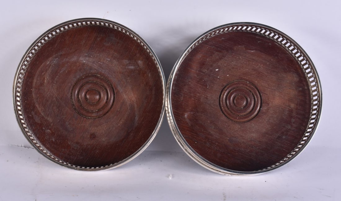 A PAIR OF SILVER BOTTLE COASTERS. 12.5 cm wide.: A PAIR OF SILVER BOTTLE COASTERS. 12.5 cm wide.