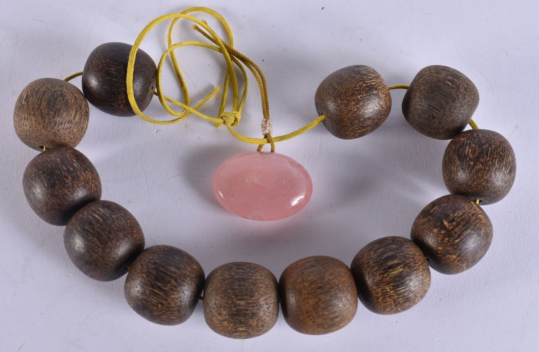 A CHINESE CHENXIANG AND ROSE QUARTZ BRACELET. 30 cm long overall.: A CHINESE CHENXIANG AND ROSE QUARTZ BRACELET. 30 cm long overall.