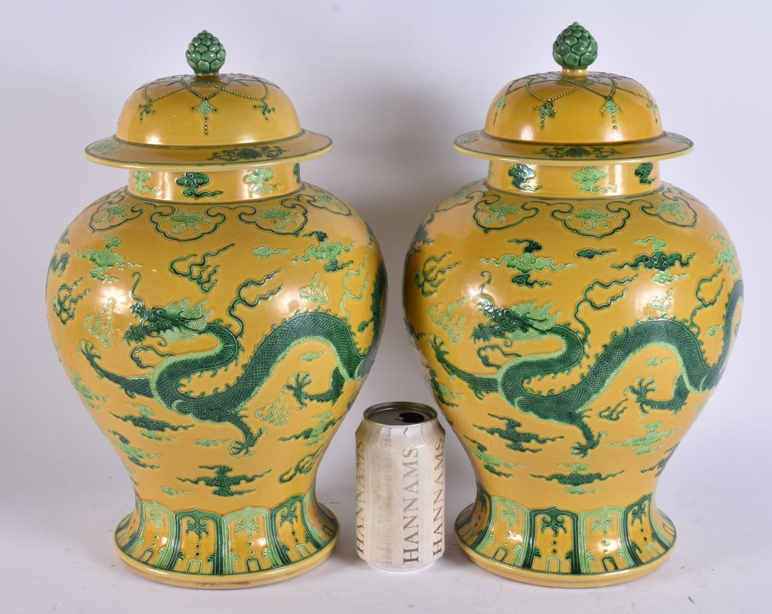 A LARGE PAIR OF CHINESE IMPERIAL YELLOW GLAZED PORCELAIN VASES AND COVERS formed with relief dragons (1 of 6)