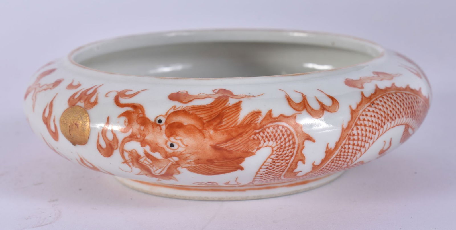 A CHINESE IRON RED PORCELAIN DRAGON BRUSH WASHER Guangxu mark and probably of the period. 12 cm diam: A CHINESE IRON RED PORCELAIN DRAGON BRUSH WASHER Guangxu mark and probably of the period. 12 cm diameter.
