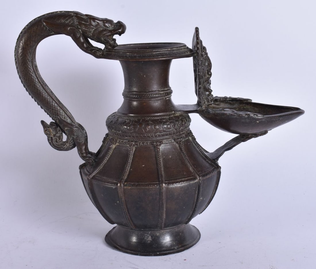 A FINE 18TH/19TH CENTURY TIBETAN NEPALESE BRONZE JUG formed with a beast handle. 19 cm x 19 cm. (1 of 11)