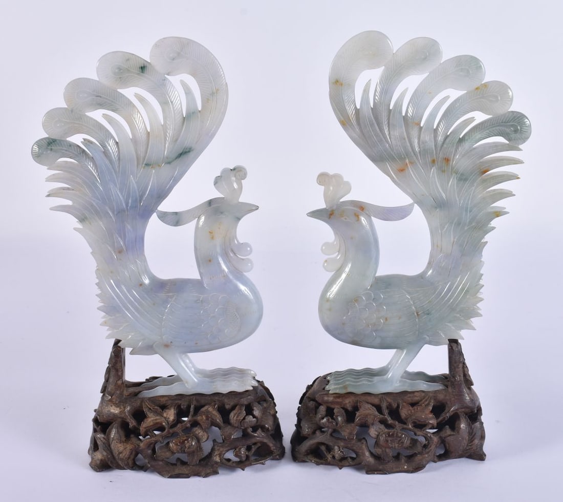 A FINE PAIR OF 19TH CENTURY CHINESE CARVED LAVENDER JADEITE BIRDS Late Qing, upon possible Zitan bas: A FINE PAIR OF 19TH CENTURY CHINESE CARVED LAVENDER JADEITE BIRDS Late Qing, upon possible Zitan bases. Jade 18 cm x 8 cm.
