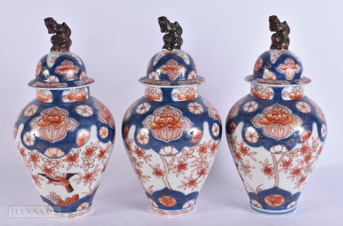 A SET OF THREE 18TH CENTURY JAPANESE EDO PERIOD IMARI VASES AND COVERS painted with birds and flower (1 of 5)