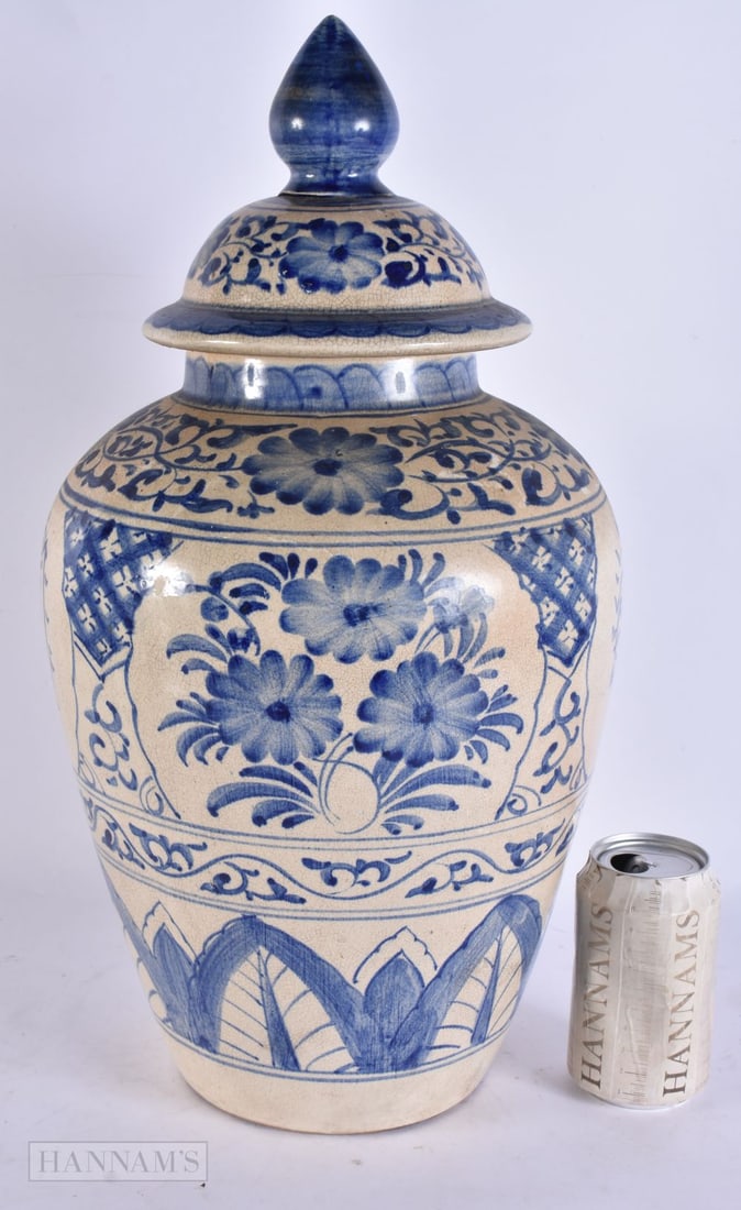 AN UNUSUAL ISLAMIC POTTERY JAR AND COVER. 47 cm high. (1 of 5)