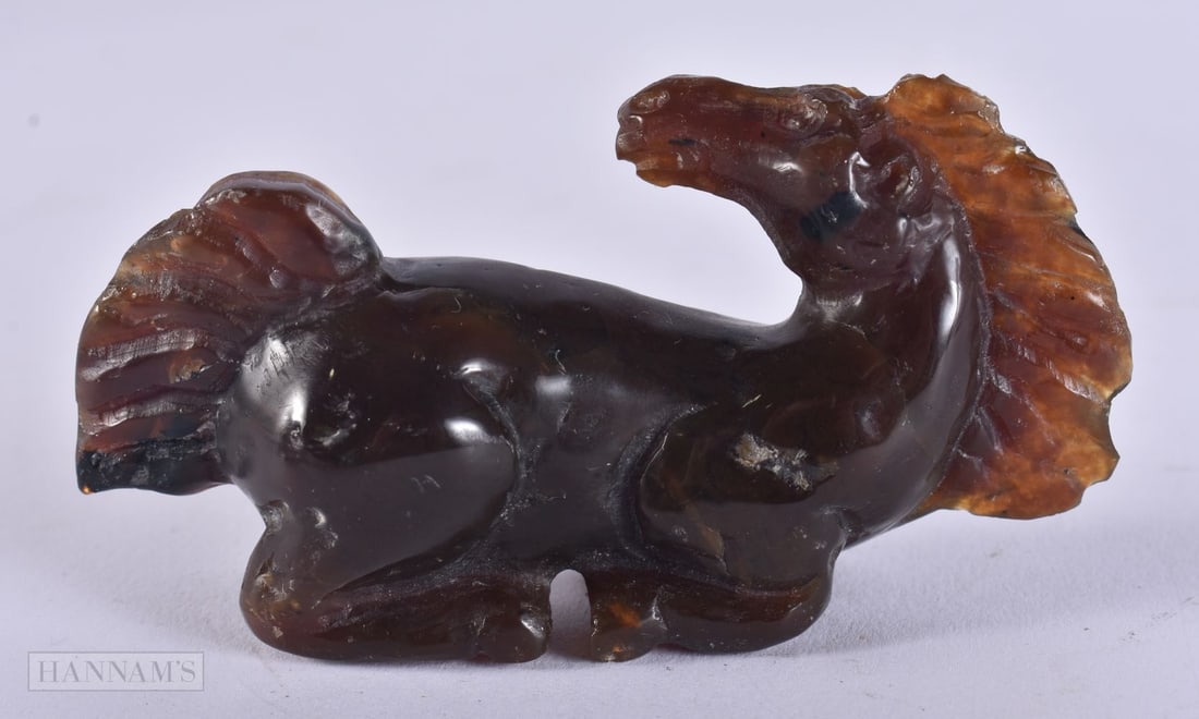 A CARVED HORN HORSE. 33 grams. 8.5 cm x 4 cm.: A CARVED HORN HORSE. 33 grams. 8.5 cm x 4 cm.