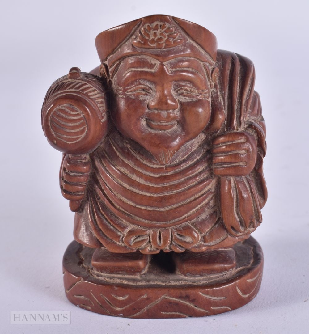 A JAPANESE WOOD FIGURE OF DAIKOKU. 103 grams. 7.5 cm x 5.5 cm.: A JAPANESE WOOD FIGURE OF DAIKOKU. 103 grams. 7.5 cm x 5.5 cm.