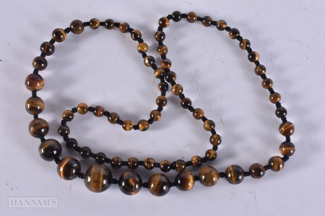 A TIGERS EYE NECKLACE. 49 grams. 67 cm long. (1 of 3)