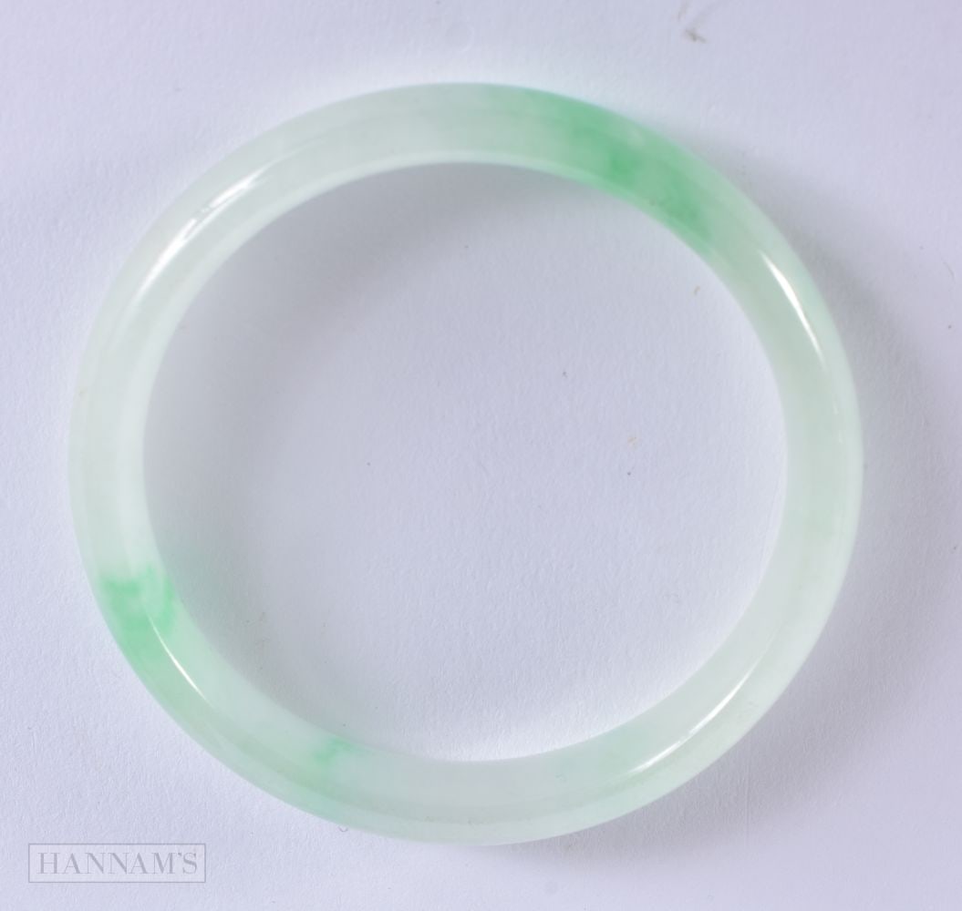 A CHINESE CARVED JADEITE BRACELET. 6.5 cm wide. (1 of 4)