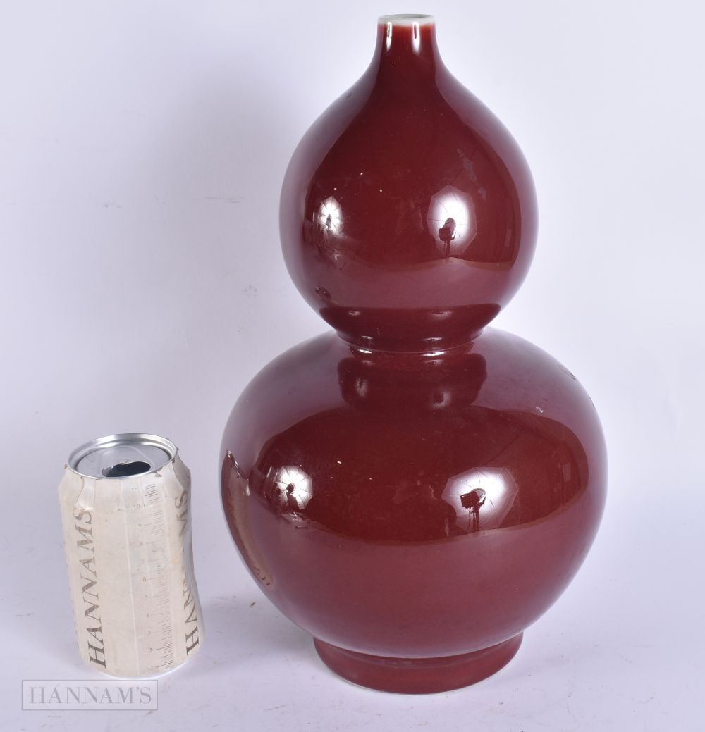 A CHINESE SANG DE BOEUF DOUBLE GOURD VASE. 32 cm high. (1 of 4)