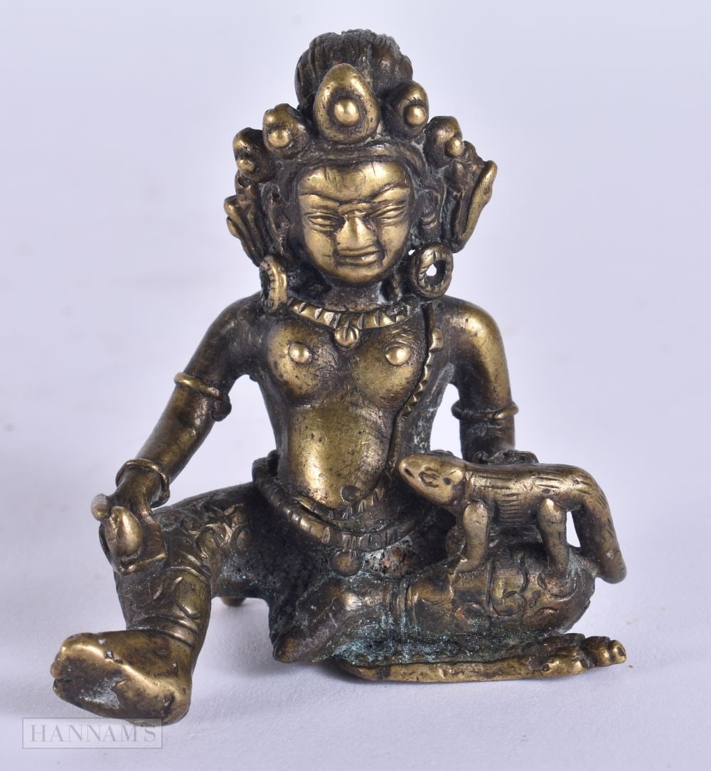 A 17TH/18TH CENTURY CHINESE TIBETAN BRONZE FIGURE OF A BUDDHA Ming, modelled holding an animal. 6.25 (1 of 12)