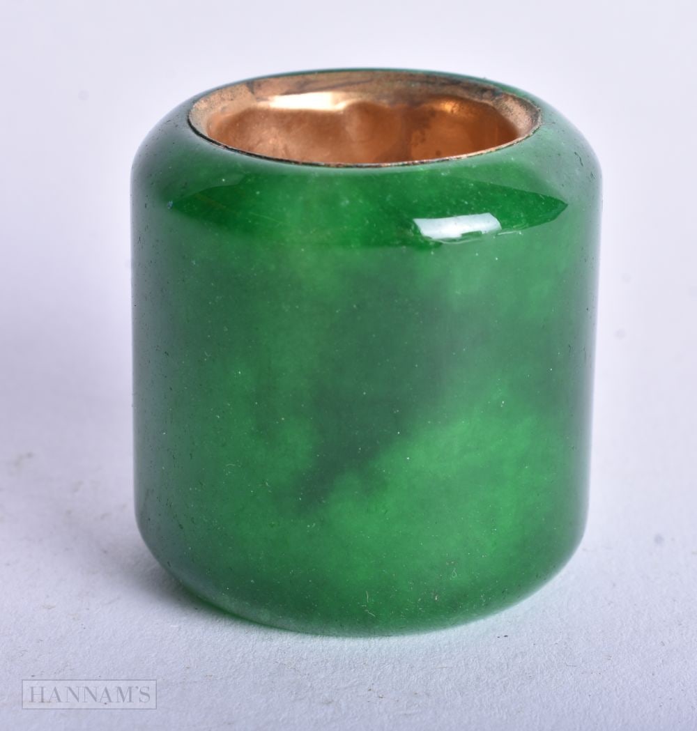 A Green Jade Archers Ring with a Gilt inner. 2.3cm internal diameter, weight 57.2g (1 of 3)