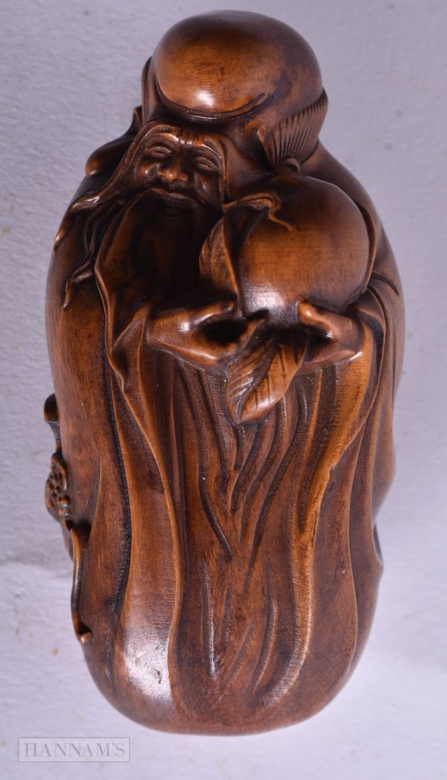 A Carved figure of Shou Lao holding the Peach of Immortality. 7.3cm x 3.6cm x 3.3cm, weight 43g (1 of 3)