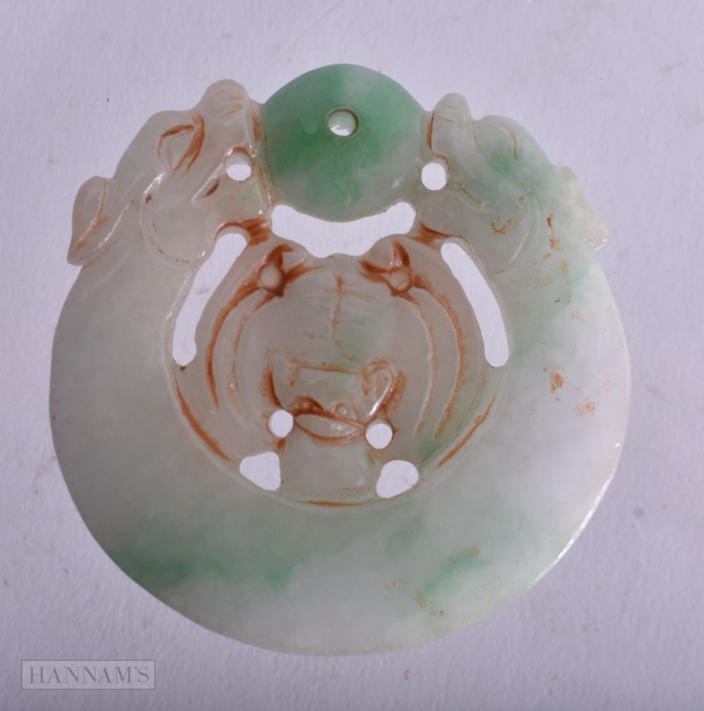 A Carved Jade Pendant. 5.2cm diameter, weight 40.4g (1 of 2)