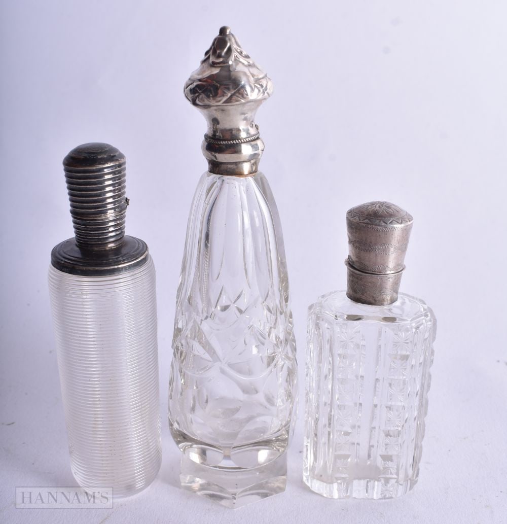 Three Silver Mounted Glass Scent Bottles. Dutch Marks, weight 163g. Largest 11.7cm high. (3): Three Silver Mounted Glass Scent Bottles. Dutch Marks, weight 163g. Largest 11.7cm high. (3)