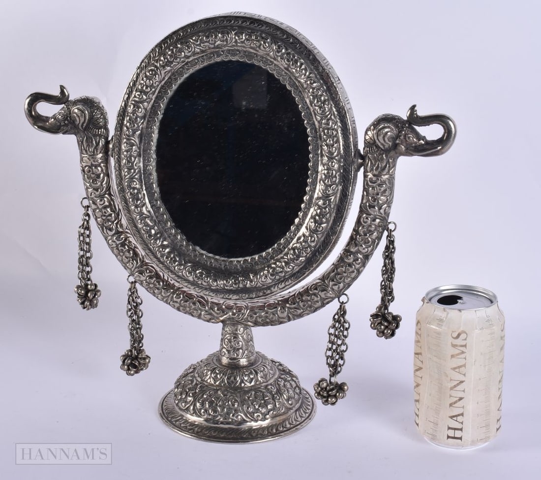 AN INDIAN WHITE METAL MIRROR. 1138 grams overall. 32 cm x 22 cm.: AN INDIAN WHITE METAL MIRROR. 1138 grams overall. 32 cm x 22 cm.