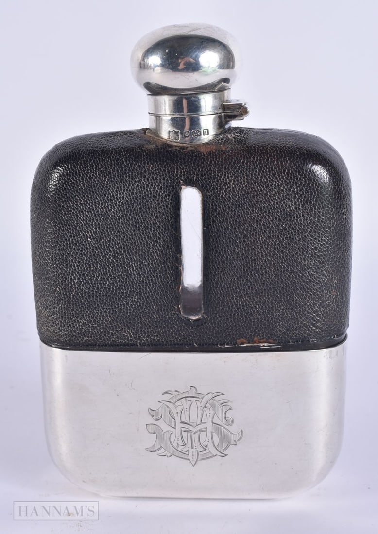 AN ANTIQUE SILVER MOUNTED LEATHER HIP FLASK. Weighable silver 96 grams. 15 cm x 9 cm. (1 of 7)