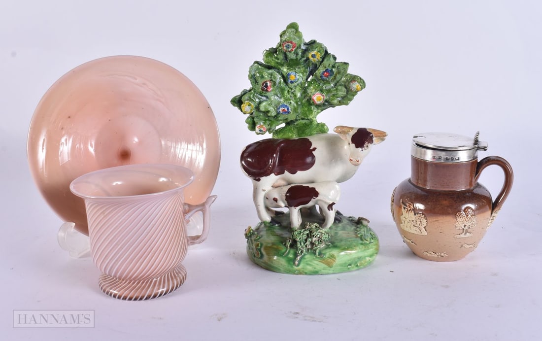 AN ANTIQUE SILVER MOUNTED STONEWARE MINIATURE CRUET JUG together with a glass cup and saucer etc. (3: AN ANTIQUE SILVER MOUNTED STONEWARE MINIATURE CRUET JUG together with a glass cup and saucer etc. (3)