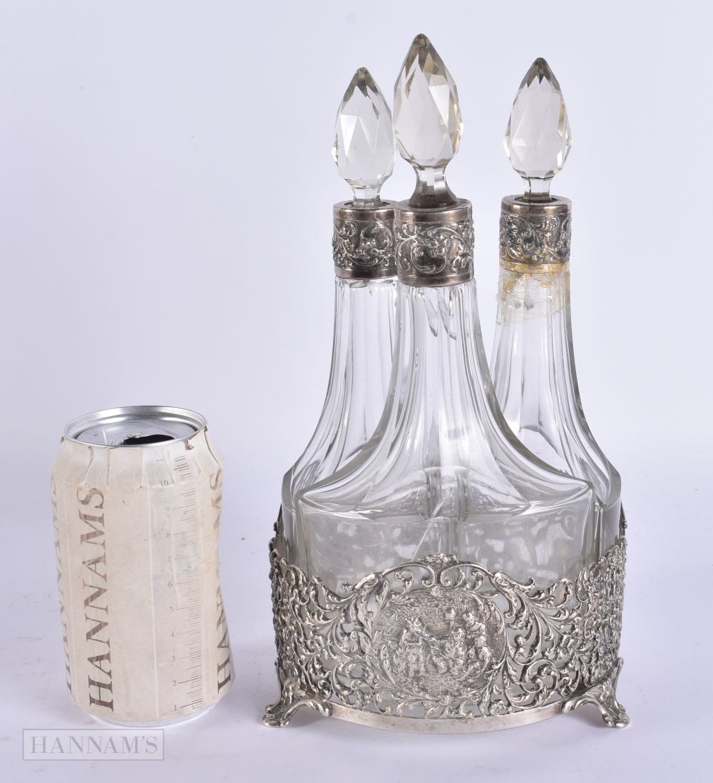 AN ANTIQUE ENGLISH THREE BOTTLE SILVER MOUNTED CRUET SET. Weighable silver 348 grams. 27cm high.: AN ANTIQUE ENGLISH THREE BOTTLE SILVER MOUNTED CRUET SET. Weighable silver 348 grams. 27cm high.