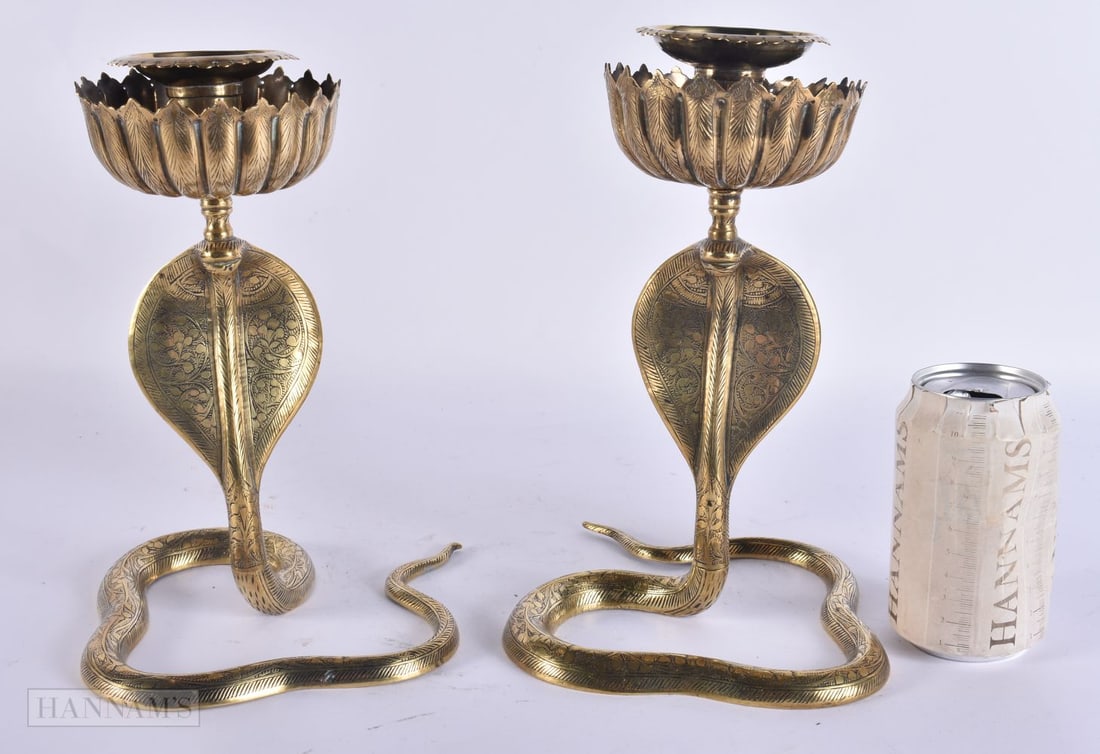 A PAIR OF INDIAN BRONZE COBRA CANDLESTICKS. 25 cm high.: A PAIR OF INDIAN BRONZE COBRA CANDLESTICKS. 25 cm high.