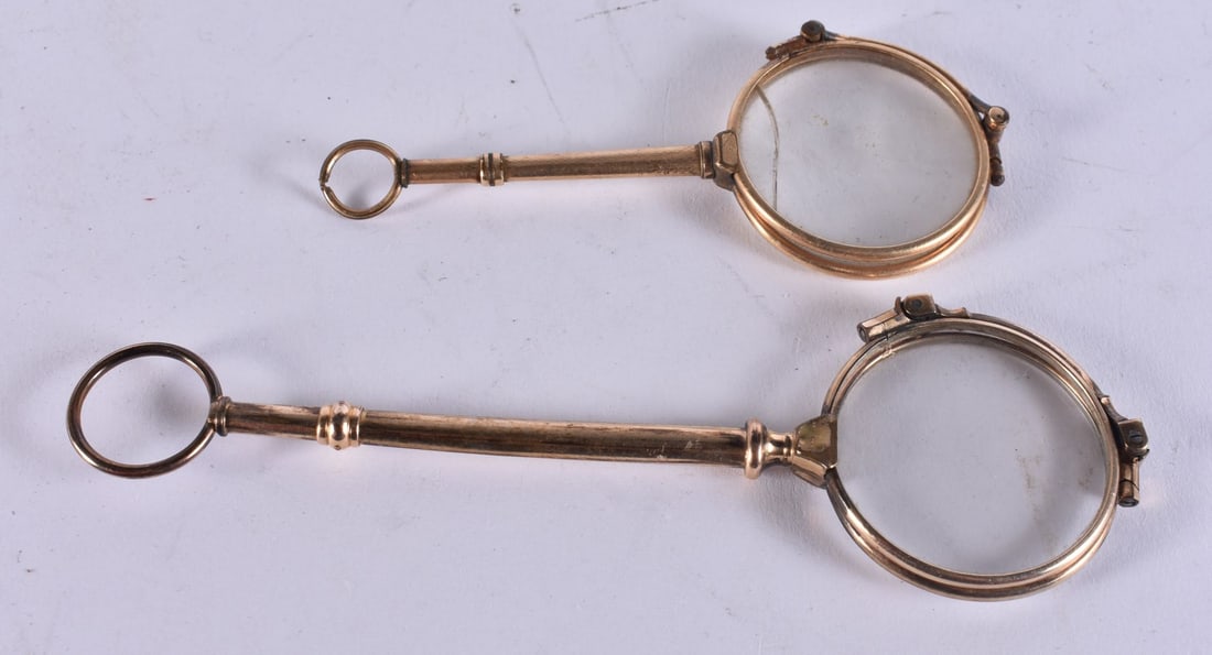 TWO PAIRS OF YELLOW METAL LORGNETTES. Largest 13.5 cm long. (2) (1 of 2)
