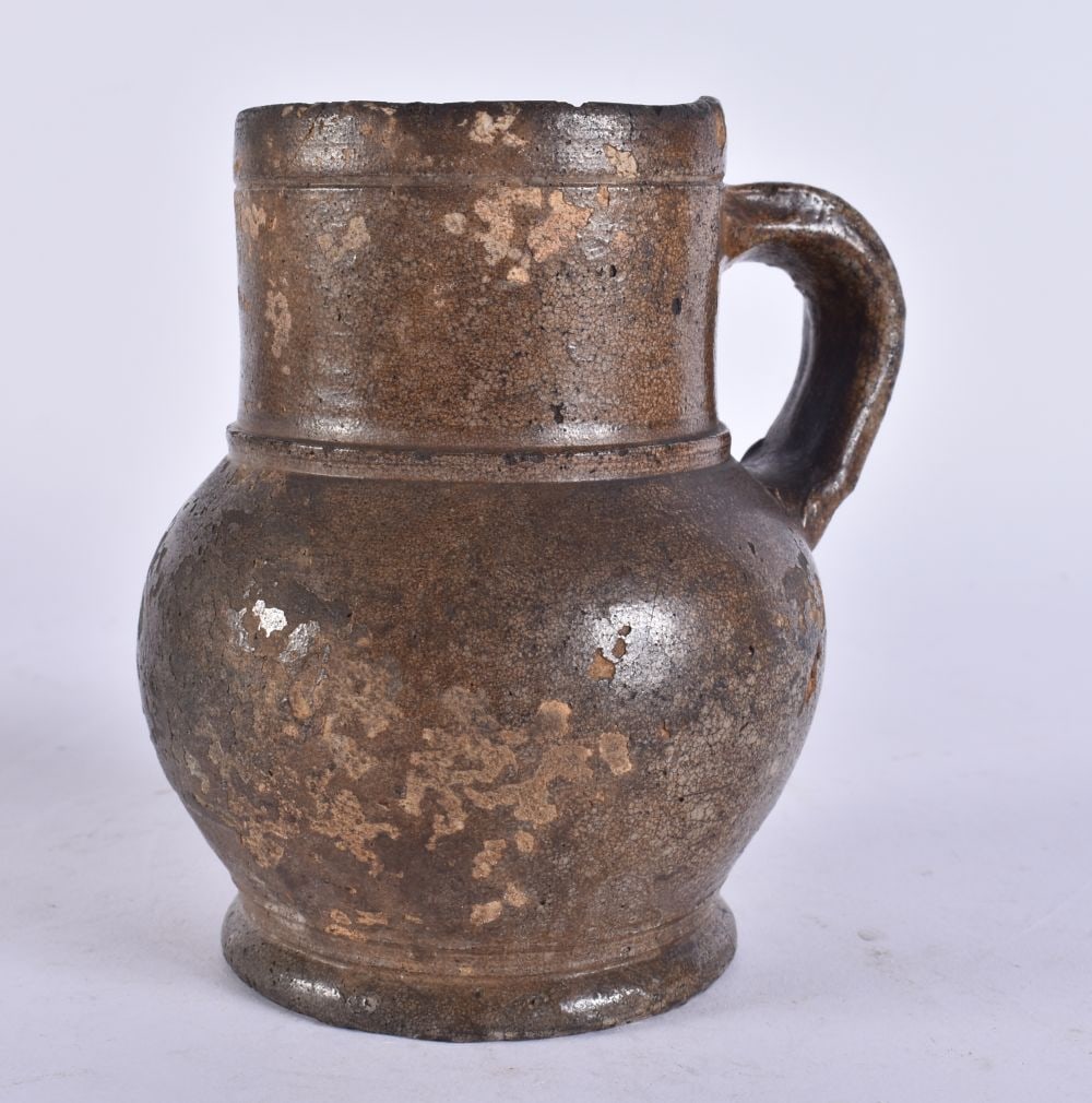 A 17TH/18TH CENTURY ENGLISH STONEWARE TAVERN MUG. 13 cm high. (1 of 5)