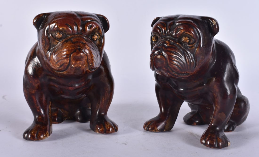 A PAIR OF 19TH CENTURY TREACLE GLAZED POTTERY FIGURES OF DOGS. 15 cm x 12 cm. (1 of 4)