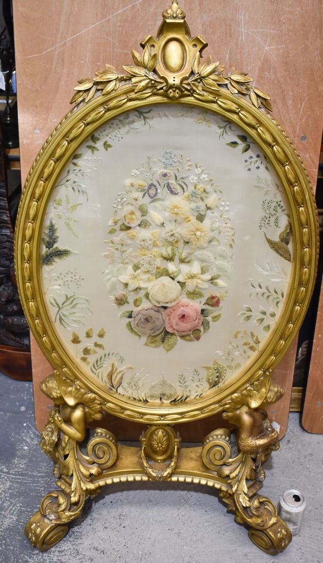 A LOVELY 19TH CENTURY FRENCH GILTWOOD COUNTRY HOUSE GILTWOOD SCREEN inset with a fine quality floral: A LOVELY 19TH CENTURY FRENCH GILTWOOD COUNTRY HOUSE GILTWOOD SCREEN inset with a fine quality floral panel, supported by putti holding garlands. 120 cm x 62 cm.
