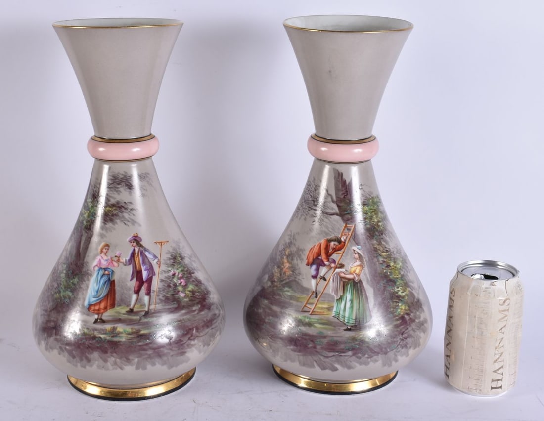 A LARGE PAIR OF VICTORIAN PORCELAIN VASES painted with figures in landscapes. 33.5 cm high. (1 of 6)