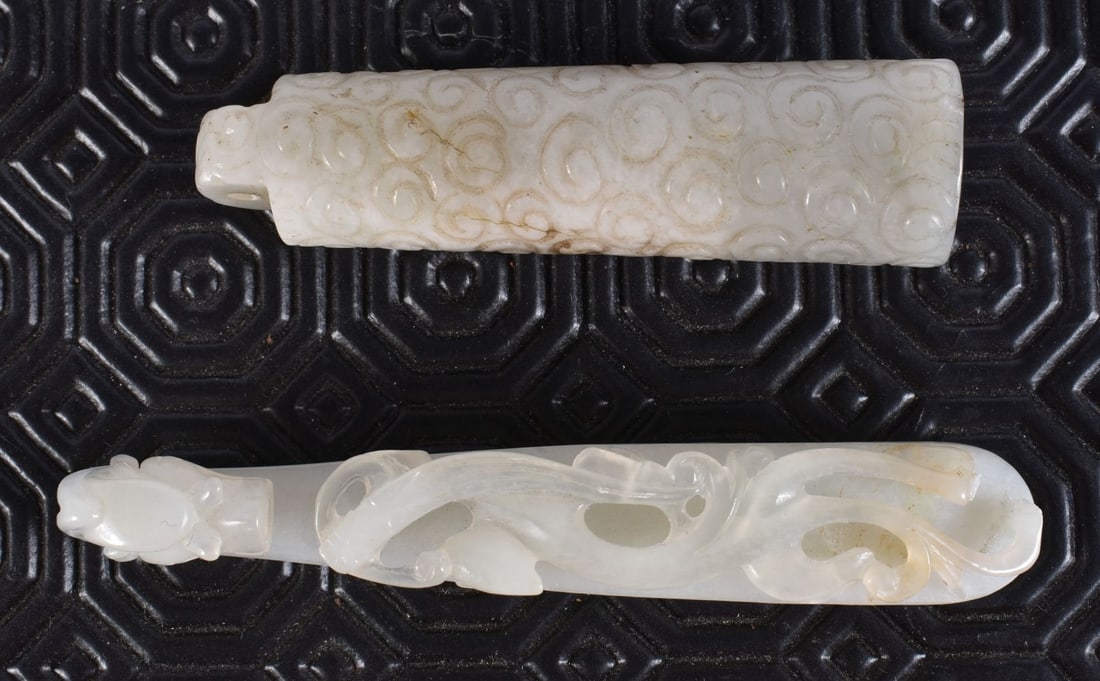A CHINESE QING DYNASTY GREENISH WHITE JADE BELT HOOK together with a jade toggle. Largest 10 cm long (1 of 5)