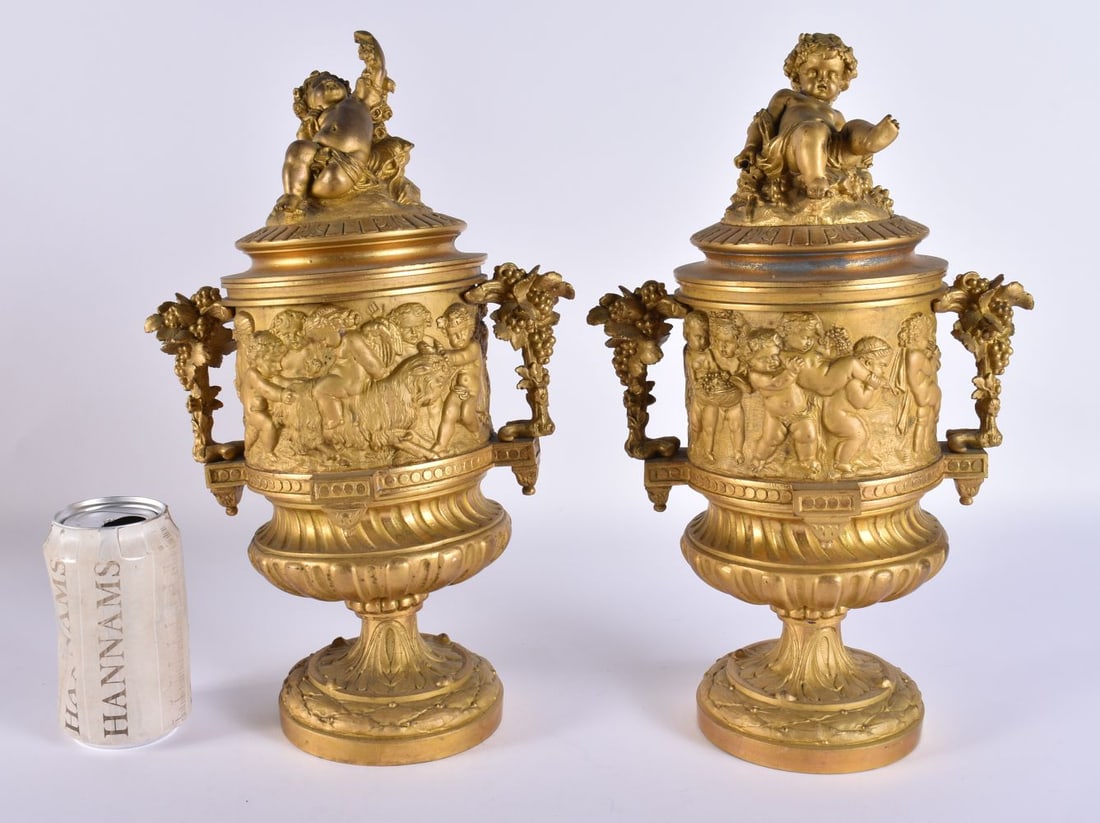 A PAIR OF 19TH CENTURY FRENCH GILT BRONZE CLASSICAL CUPS AND COVERS formed with bacchanalian figures (1 of 8)