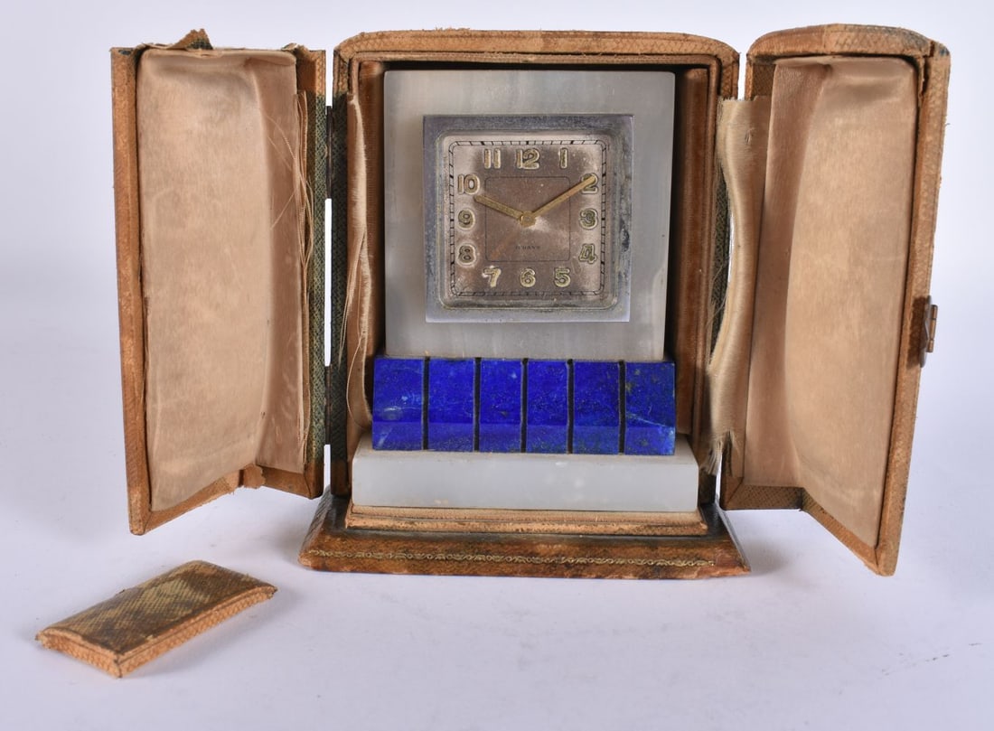AN ART DECO HARRODS OF LONDON ONYX AND LAPIS LAZULI CLOCK within fitted case. Not running. 11.5 cm x: AN ART DECO HARRODS OF LONDON ONYX AND LAPIS LAZULI CLOCK within fitted case. Not running. 11.5 cm x 8.5 cm.