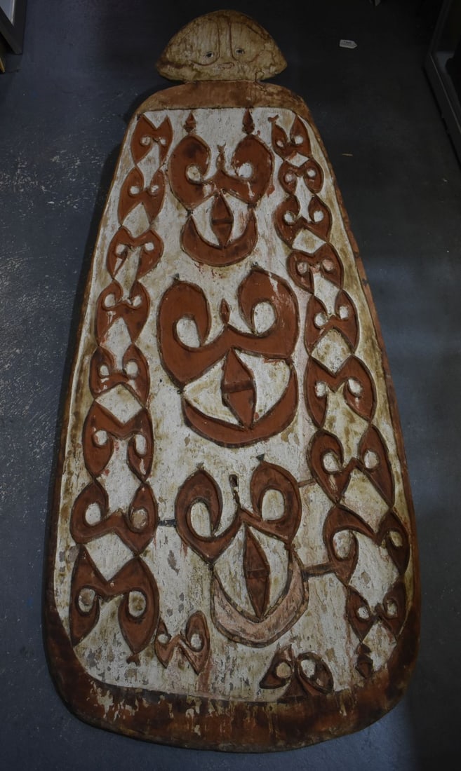 A LARGE ANTIQUE PAINTED PAPUA NEW GUINEA CARVED ASMAT SHIELD decorated with motifs. 147 cm x 50 cm. (1 of 6)