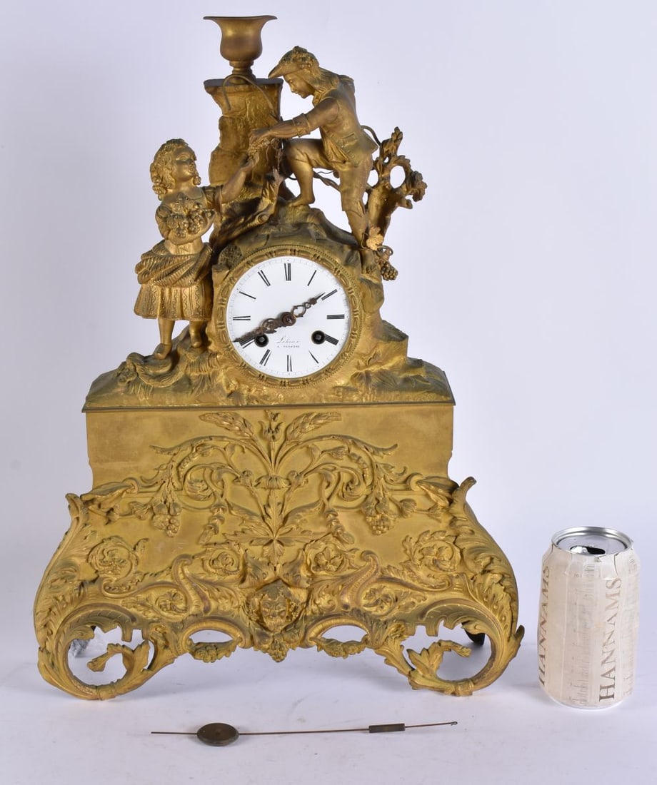A 19TH CENTURY FRENCH LEHOUX GILT BRONZE MANTEL CLOCK decorated with mask heads and foliage. 46 cm x: A 19TH CENTURY FRENCH LEHOUX GILT BRONZE MANTEL CLOCK decorated with mask heads and foliage. 46 cm x 24 cm.