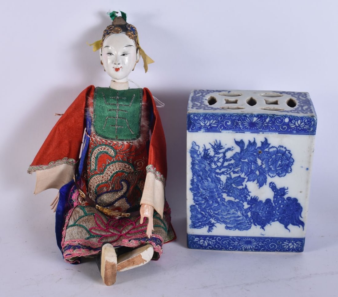 A CHINESE DOLL together with a blue and white pillow. (2) (1 of 7)