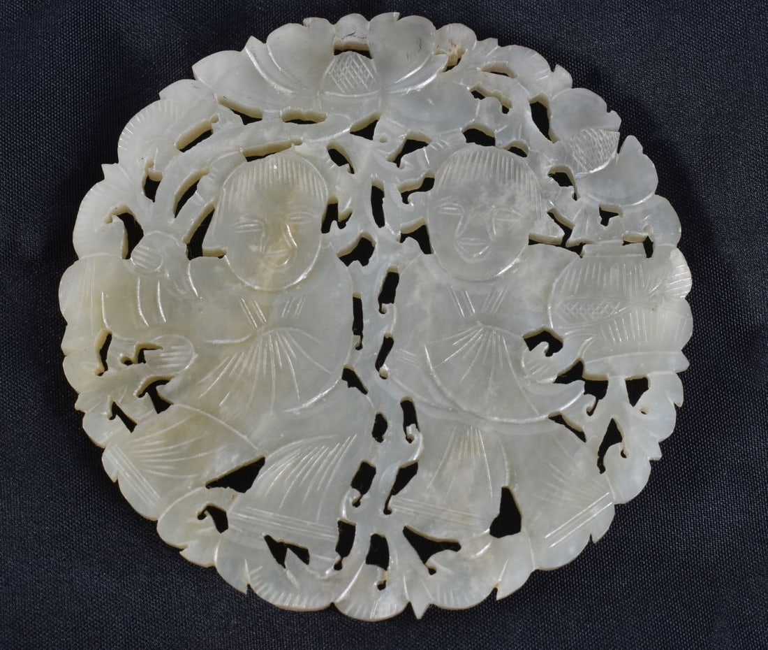 A LARGE CHINESE DYNASTY RETICULATED JADE PLAQUE formed with two boys amongst foliage. 8.5 cm wide. (1 of 5)