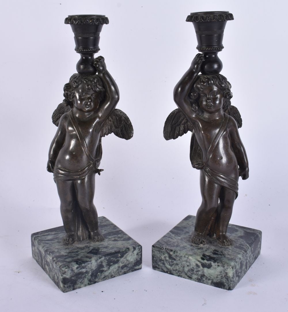 A PAIR OF 18TH CENTURY EUROPEAN BRONZE FIGURES OF PUTTI formed as candlesticks. 20 cm high. (1 of 8)