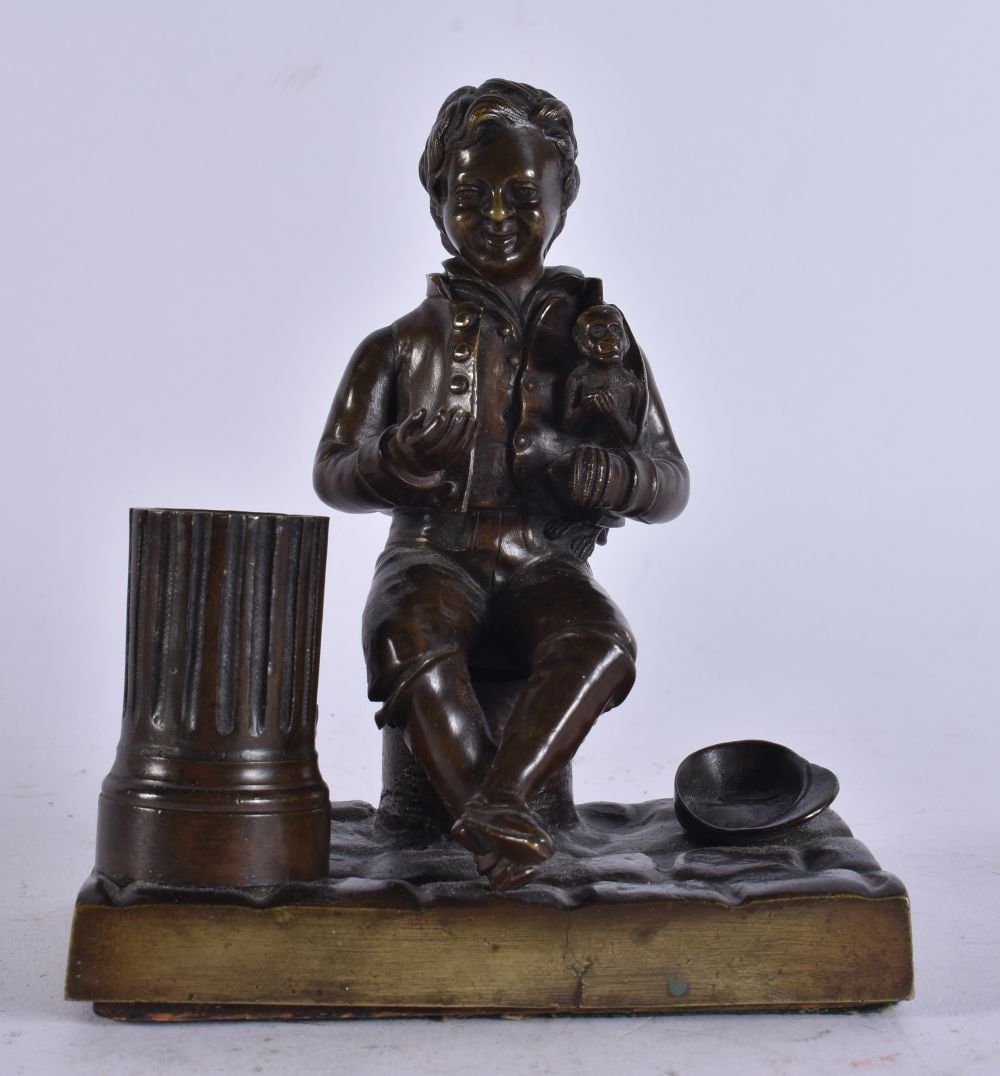 A 19TH CENTURY FRENCH BRONZE DESK STAND formed as a male holding a monkey. 15 cm x 9 cm.: A 19TH CENTURY FRENCH BRONZE DESK STAND formed as a male holding a monkey. 15 cm x 9 cm.