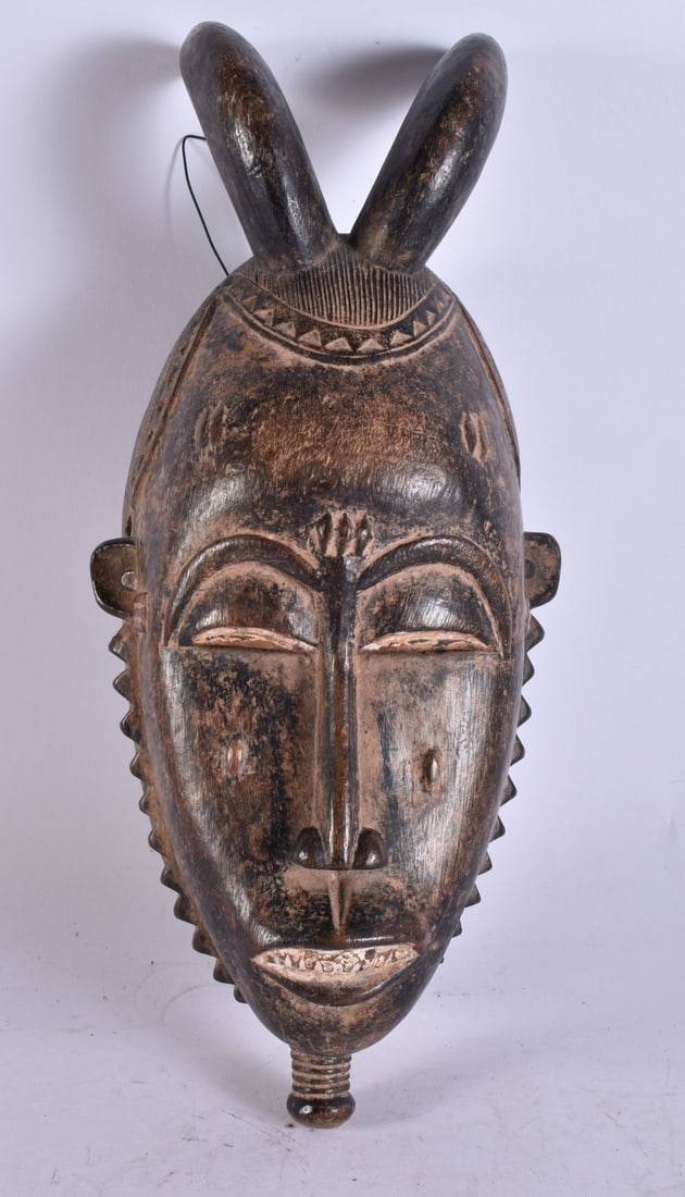 AN AFRICAN TRIBAL WOOD BAULE MASK. 38 cm x 10 cm. (1 of 3)
