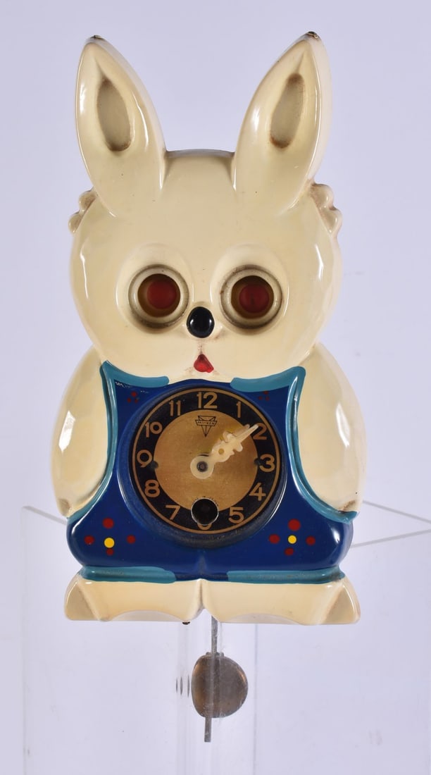 A VINTAGE CELLULOID AUTOMATON RABBIT CLOCK. 17 cm x 8 cm. (1 of 2)
