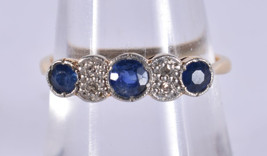 An 18ct gold three stone blue zircon and diamond ring, set with oval cushion-cut zircon and single-c (1 of 4)