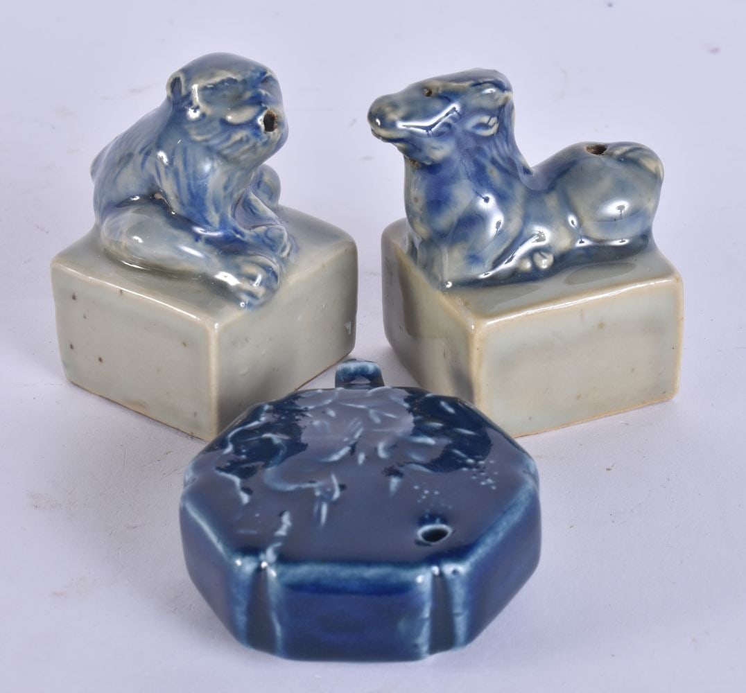 A PAIR OF SOUTH EAST ASIAN POTTERY JOSS STICK HOLDERS together with a blue monochrome water dropper. (1 of 7)