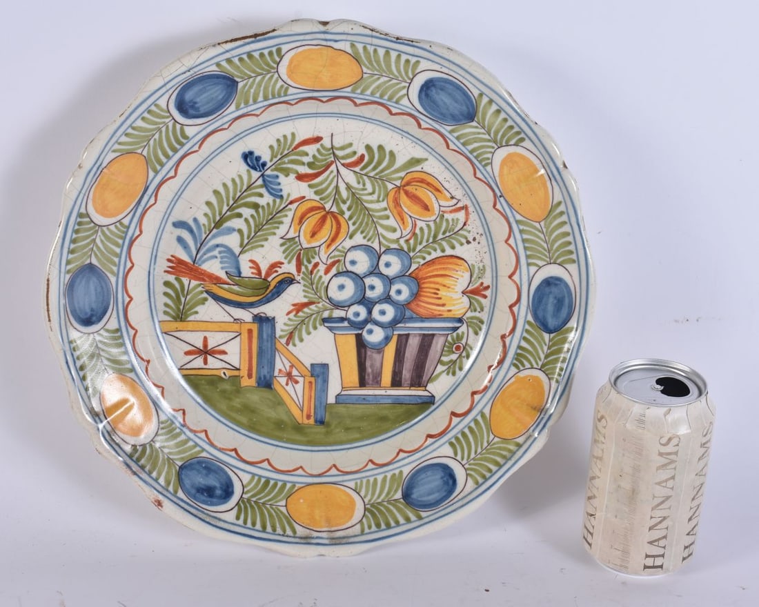 AN ANTIQUE DELFT FAIENCE POTTERY DISH painted with birds and fruit. 30 cm wide.: AN ANTIQUE DELFT FAIENCE POTTERY DISH painted with birds and fruit. 30 cm wide.